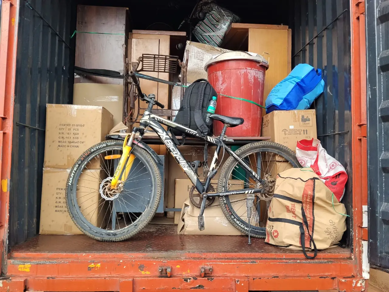 Bicycle secured with household cartons inside the truck during a house shifting