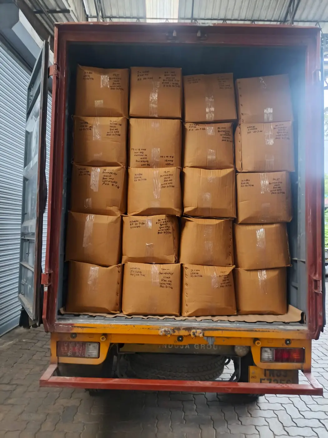 Full truck load of labelled cartons stacked for goods transport from Kerala