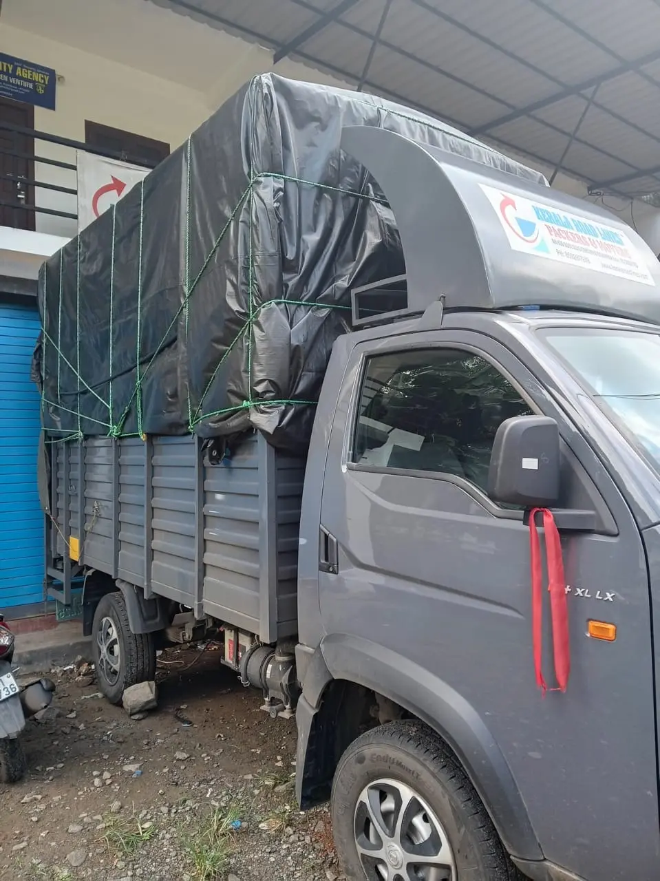 Kerala Road Lines truck loaded and tarpaulin-covered, ready to depart