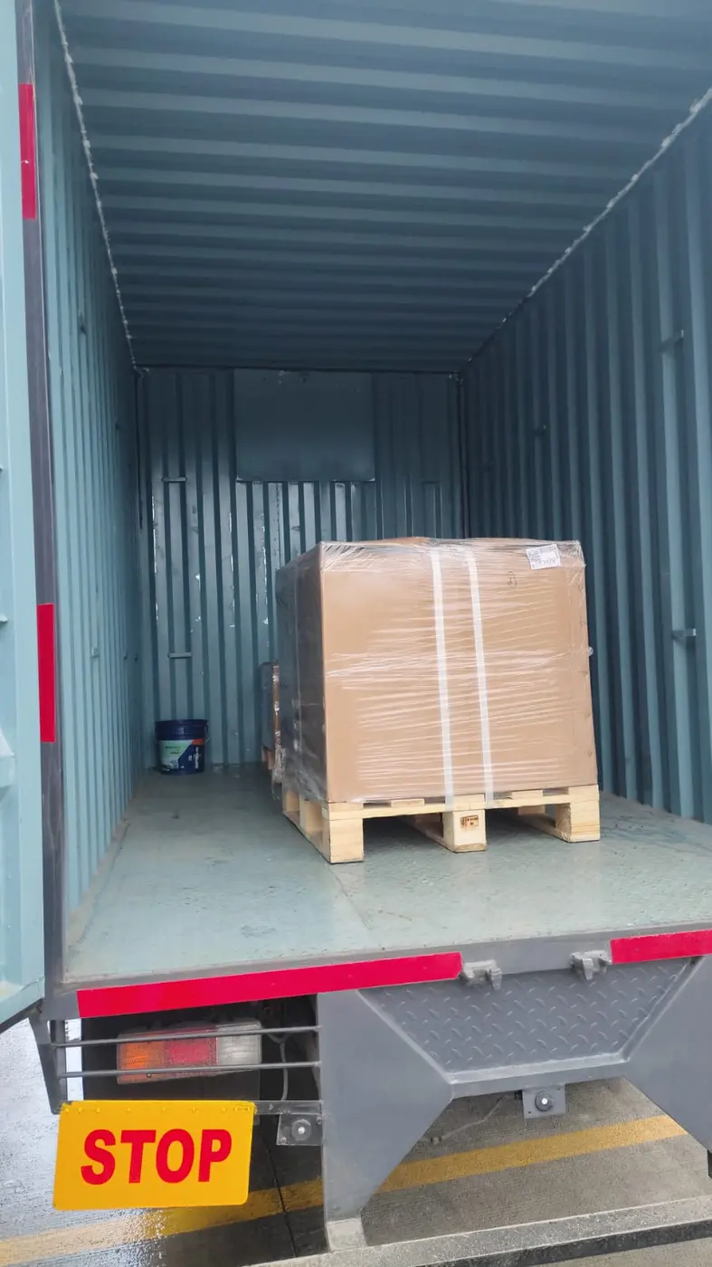 Palletised and stretch-wrapped cargo loaded inside a container truck