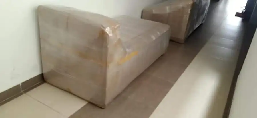 Wrapped sofas moved out through the corridor
